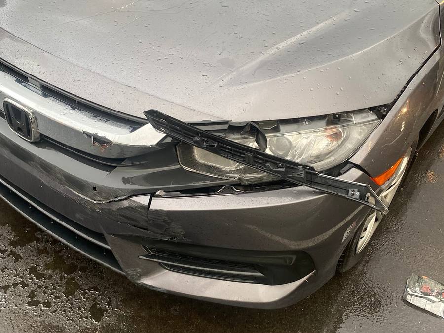 Front bumper and hood damage on a silver coupe.